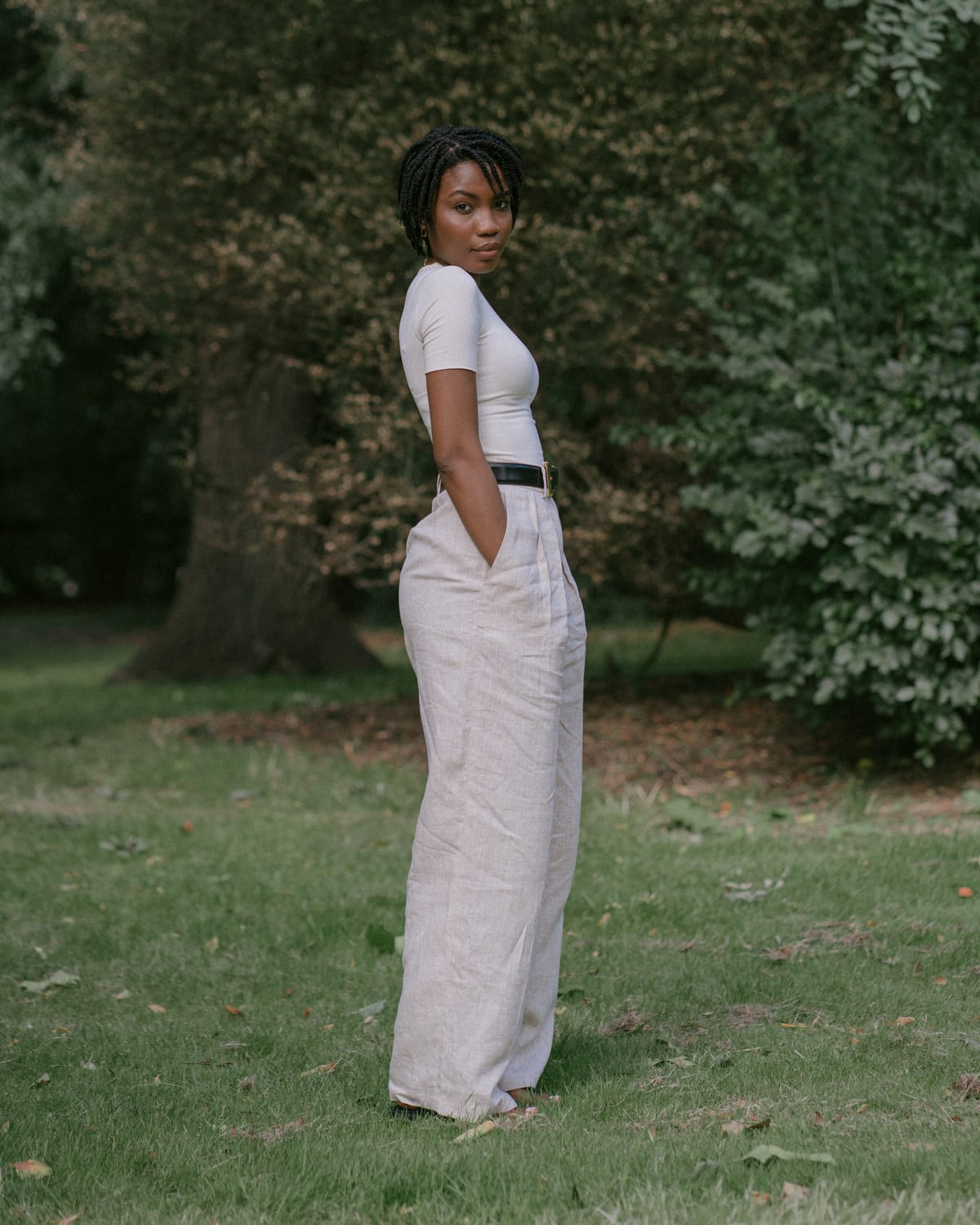 Helsa Studio linen pleated front pants in natural linen styled with white tank top — high-rise, wide-leg fit for tall women.
